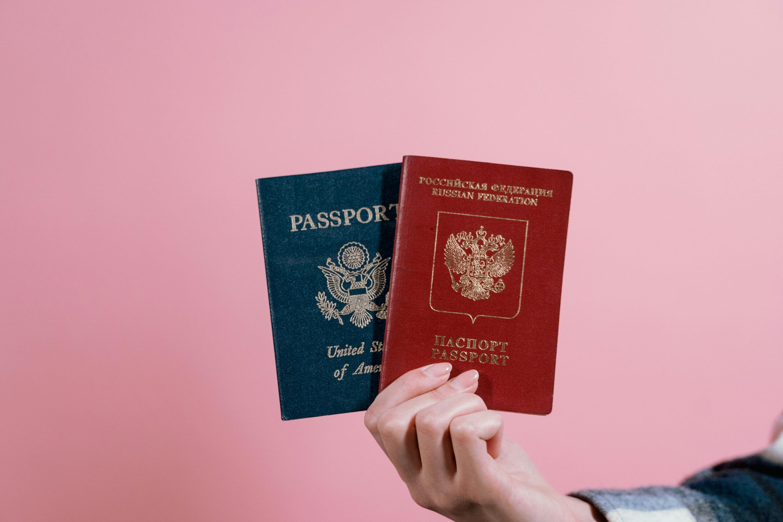 Person holding red and blue book